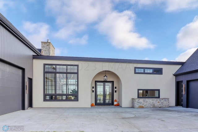 view of front facade featuring a garage and french doors