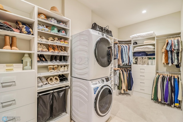 laundry area featuring stacked washer and dryer, laundry area, and carpet