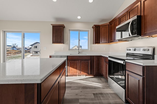 kitchen with light hardwood / wood-style floors, sink, stainless steel appliances, and a wealth of natural light