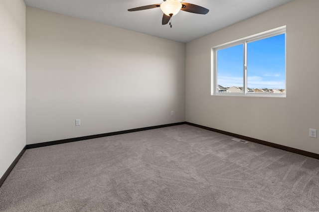 spare room featuring ceiling fan and light colored carpet