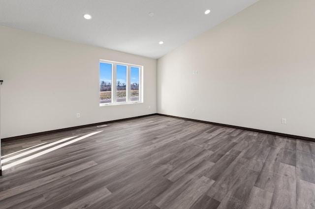 empty room with wood-type flooring and lofted ceiling