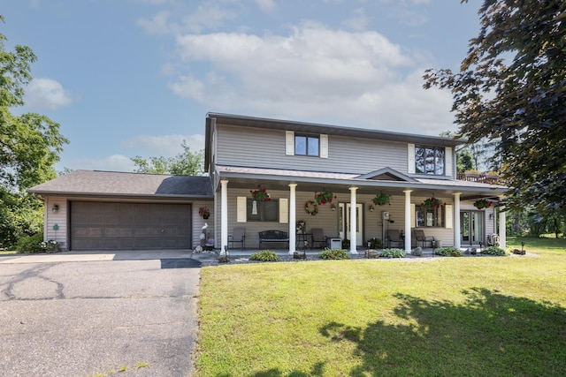 view of front facade with a garage, a front yard, and a porch