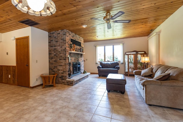 living room featuring a brick fireplace, wood ceiling, ceiling fan, and light tile patterned flooring