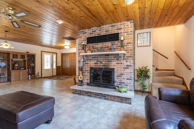 tiled living room with wood ceiling, a fireplace, and ceiling fan