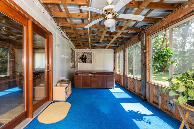 unfurnished sunroom with ceiling fan and plenty of natural light