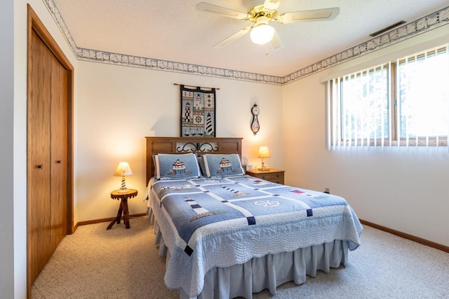 bedroom featuring a closet, ceiling fan, and carpet