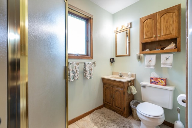 bathroom featuring vanity, toilet, and tile patterned flooring