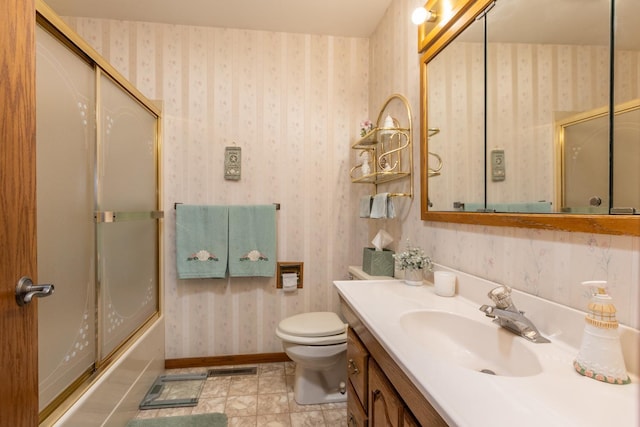 full bathroom with vanity, toilet, and combined bath / shower with glass door