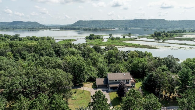 birds eye view of property with a water and mountain view