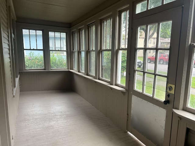 unfurnished sunroom featuring a wealth of natural light