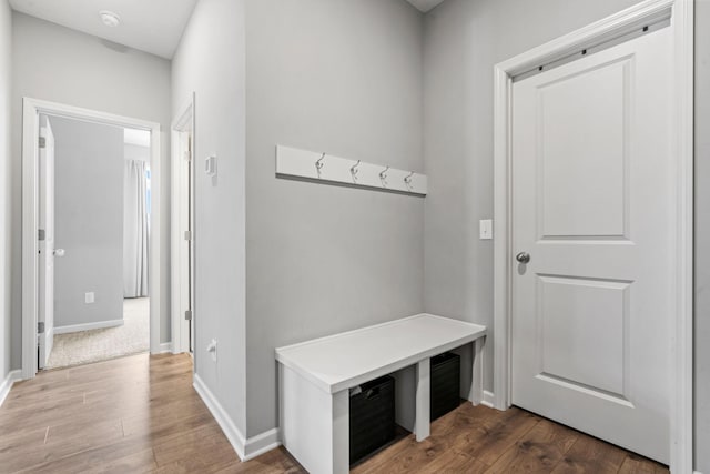 mudroom featuring baseboards and wood finished floors