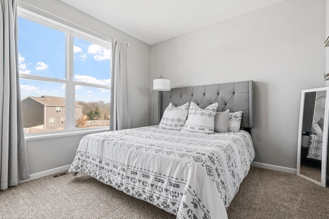 bedroom with carpet flooring and baseboards