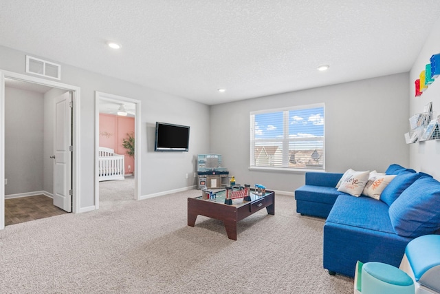 carpeted living room with recessed lighting, visible vents, a textured ceiling, and baseboards