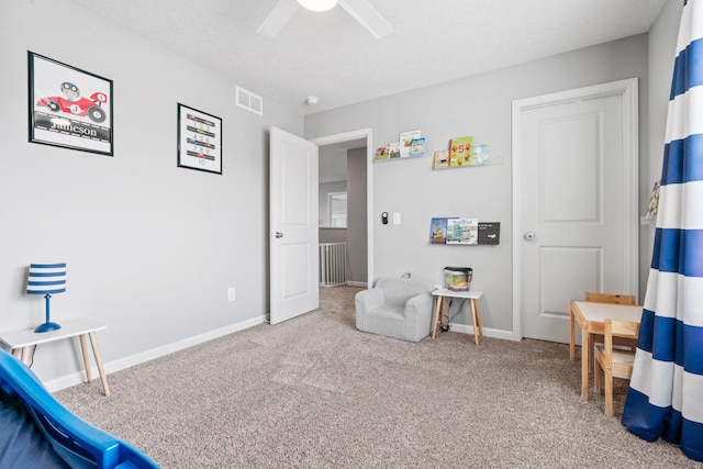 sitting room with baseboards, visible vents, ceiling fan, a textured ceiling, and carpet flooring