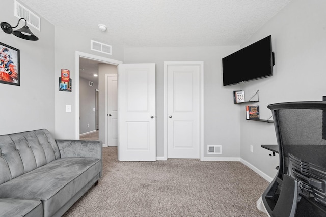 living room with baseboards, a textured ceiling, visible vents, and carpet flooring