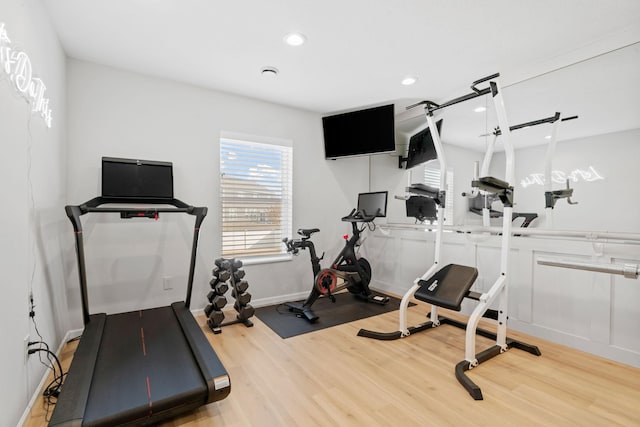 exercise area with recessed lighting, baseboards, and wood finished floors