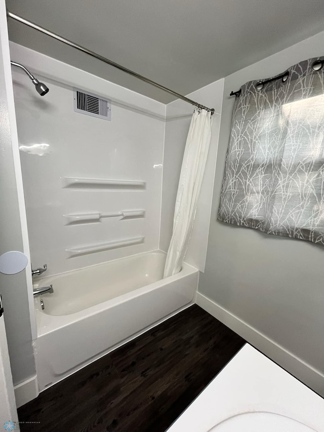 bathroom featuring shower / bath combination with curtain and hardwood / wood-style floors