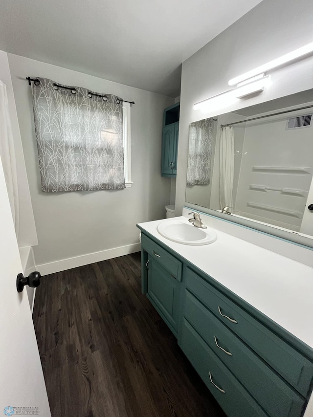 bathroom featuring a shower with shower curtain, hardwood / wood-style floors, and vanity