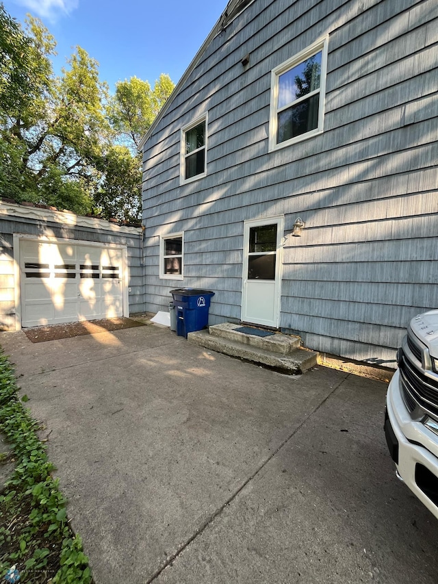 view of side of property featuring a garage and an outdoor structure