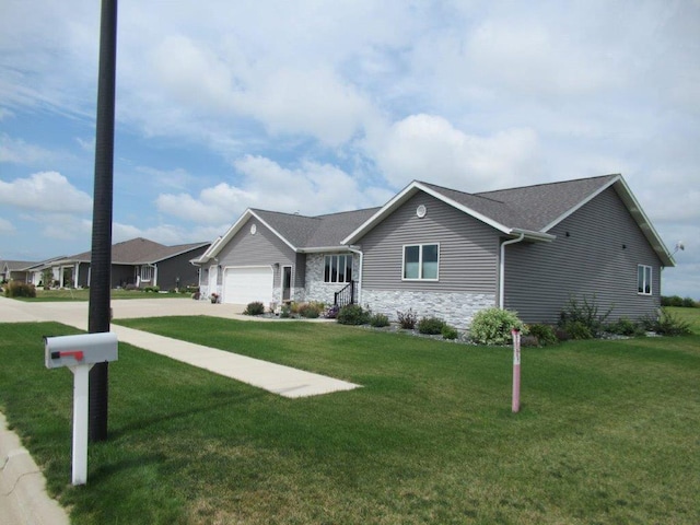 single story home featuring a garage and a front lawn