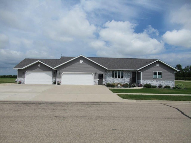 ranch-style house with a garage and a front lawn