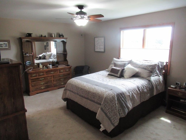 bedroom featuring ceiling fan and light colored carpet