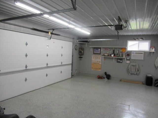 garage featuring a wall mounted air conditioner and a garage door opener