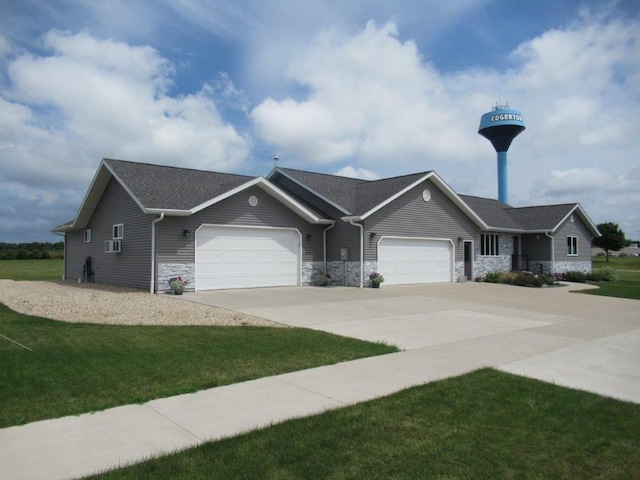 ranch-style home with a garage and a front lawn