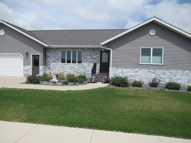 single story home with a garage and a front lawn