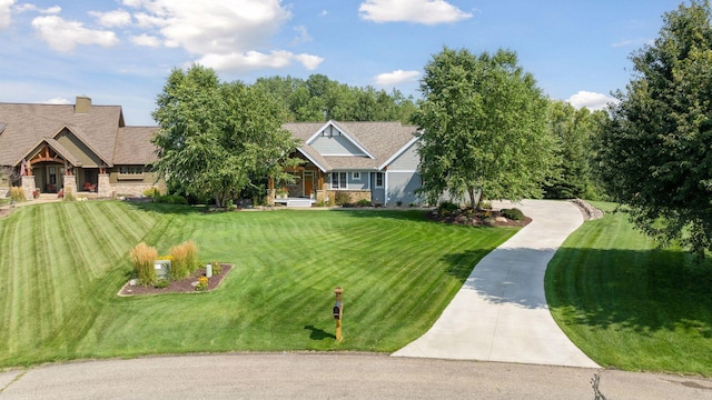 view of front of home featuring stone siding and a front lawn