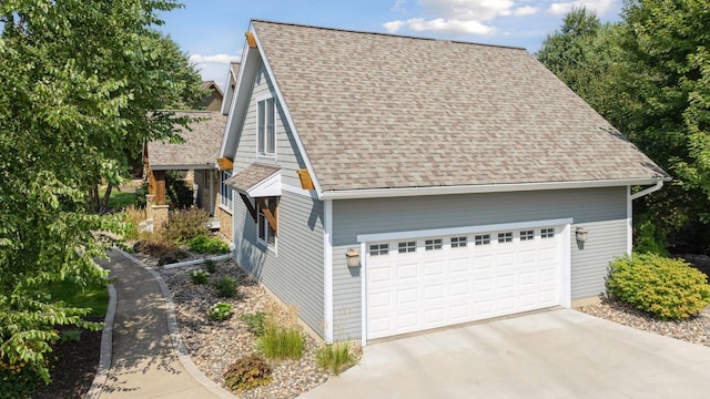 view of front of home featuring a garage and roof with shingles