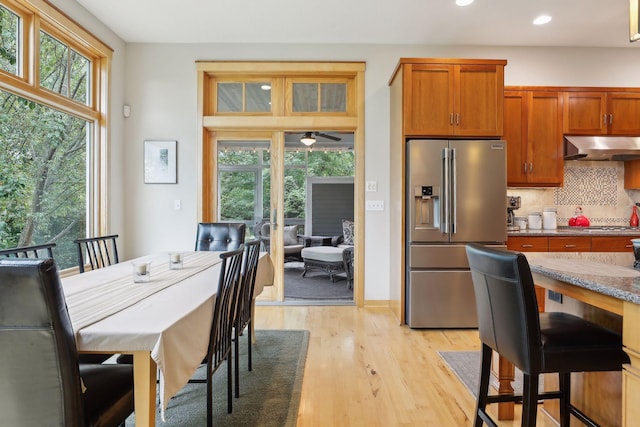 dining space featuring recessed lighting, a healthy amount of sunlight, light wood-type flooring, and french doors