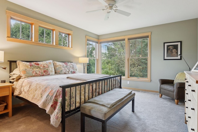 carpeted bedroom featuring a ceiling fan and baseboards