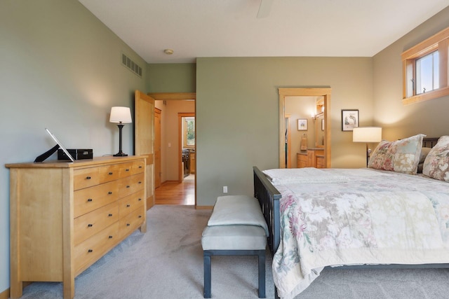 bedroom featuring light colored carpet and visible vents