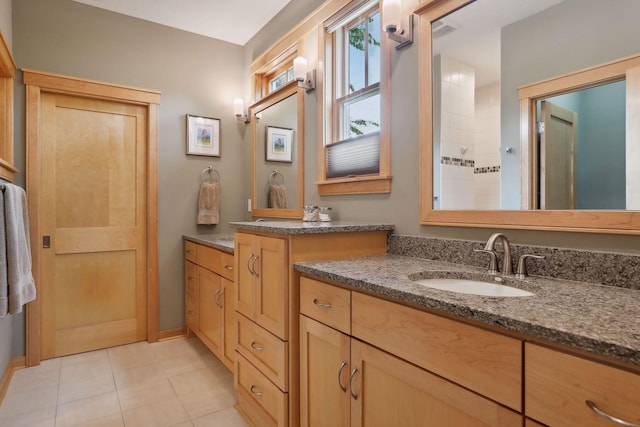 full bathroom featuring tile patterned flooring and vanity