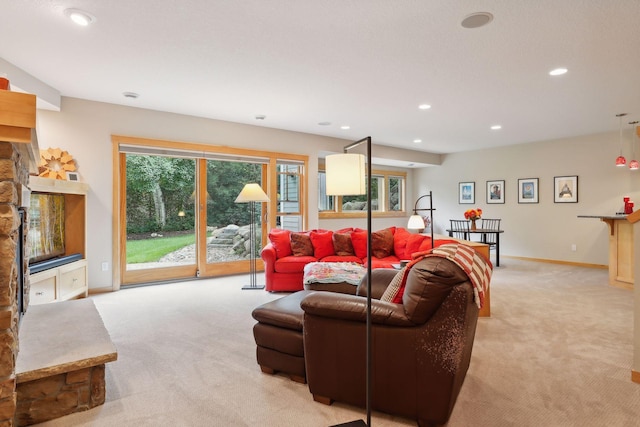 living area featuring light carpet, recessed lighting, and baseboards