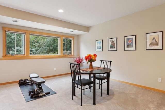 dining space with a wealth of natural light, baseboards, light carpet, and recessed lighting