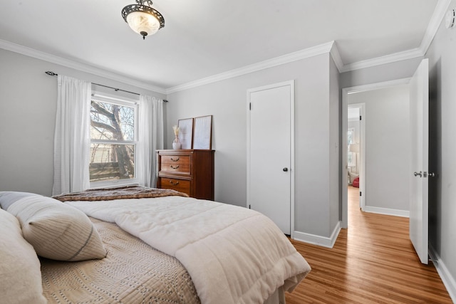 bedroom featuring ornamental molding and hardwood / wood-style floors