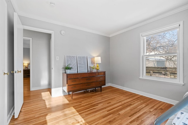 bedroom featuring crown molding and light hardwood / wood-style floors