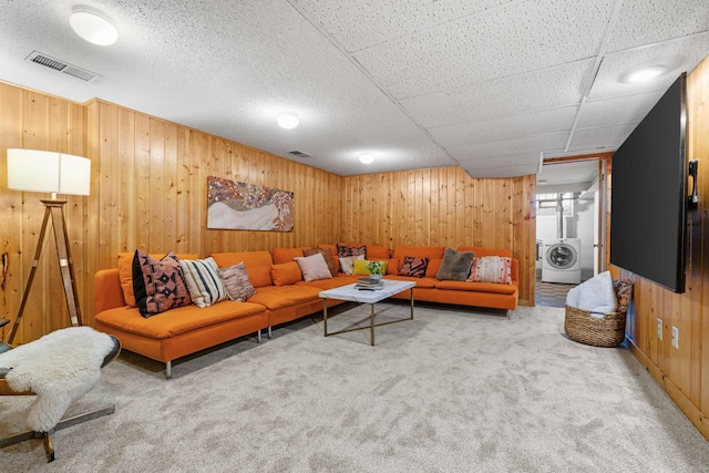 carpeted living room with washer / dryer