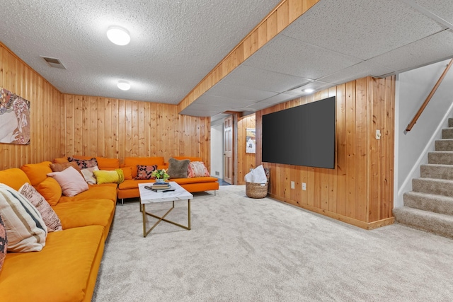 carpeted living room with wood walls