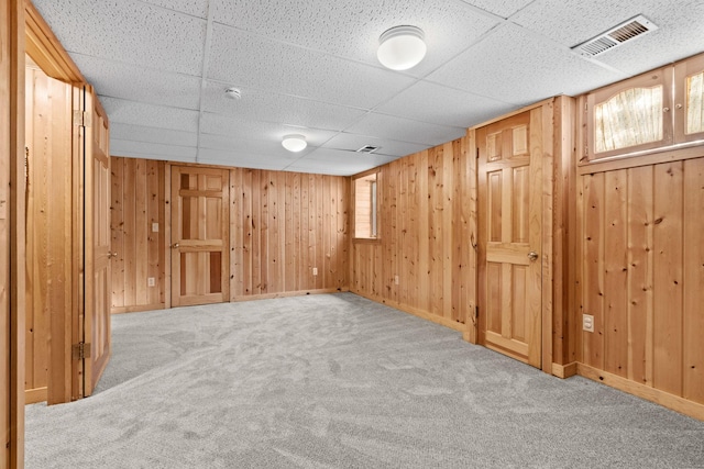 basement with carpet and a drop ceiling