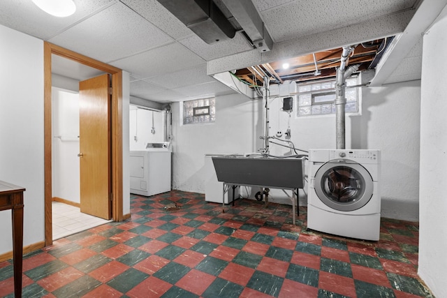 laundry area featuring washing machine and clothes dryer and sink