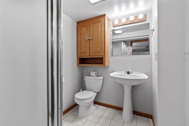 bathroom featuring toilet and tile patterned flooring