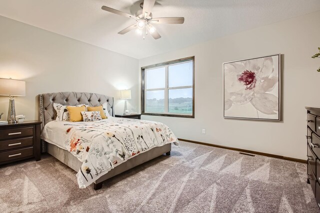 carpeted bedroom with ceiling fan