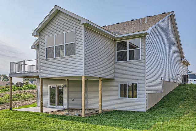 back of house featuring a patio area and a lawn