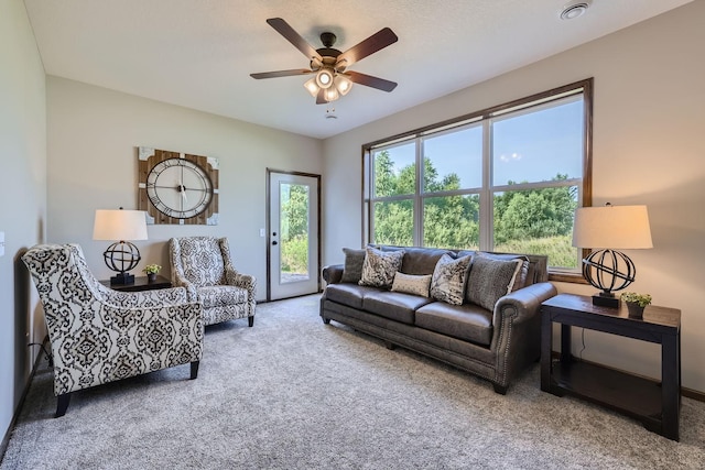 carpeted living room featuring ceiling fan