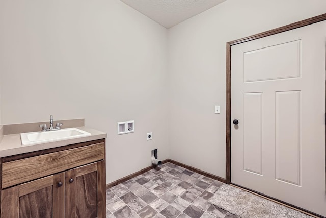 clothes washing area with a sink, cabinet space, baseboards, hookup for an electric dryer, and hookup for a washing machine