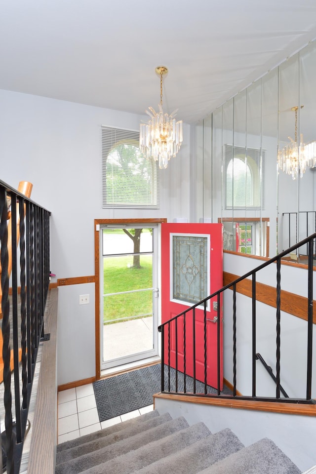 tiled foyer with a chandelier