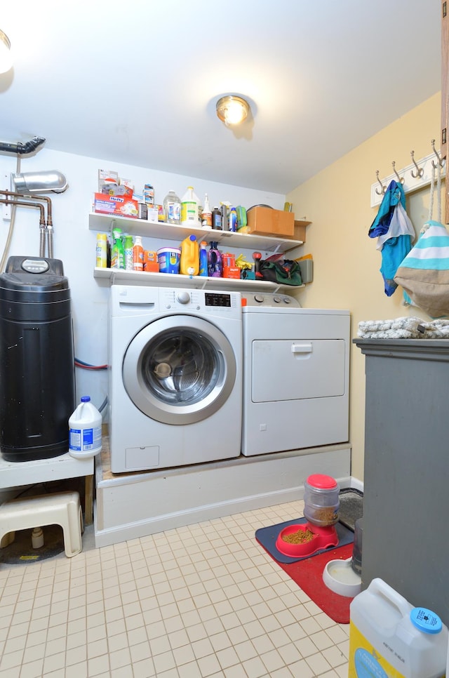 washroom with separate washer and dryer and light tile patterned floors